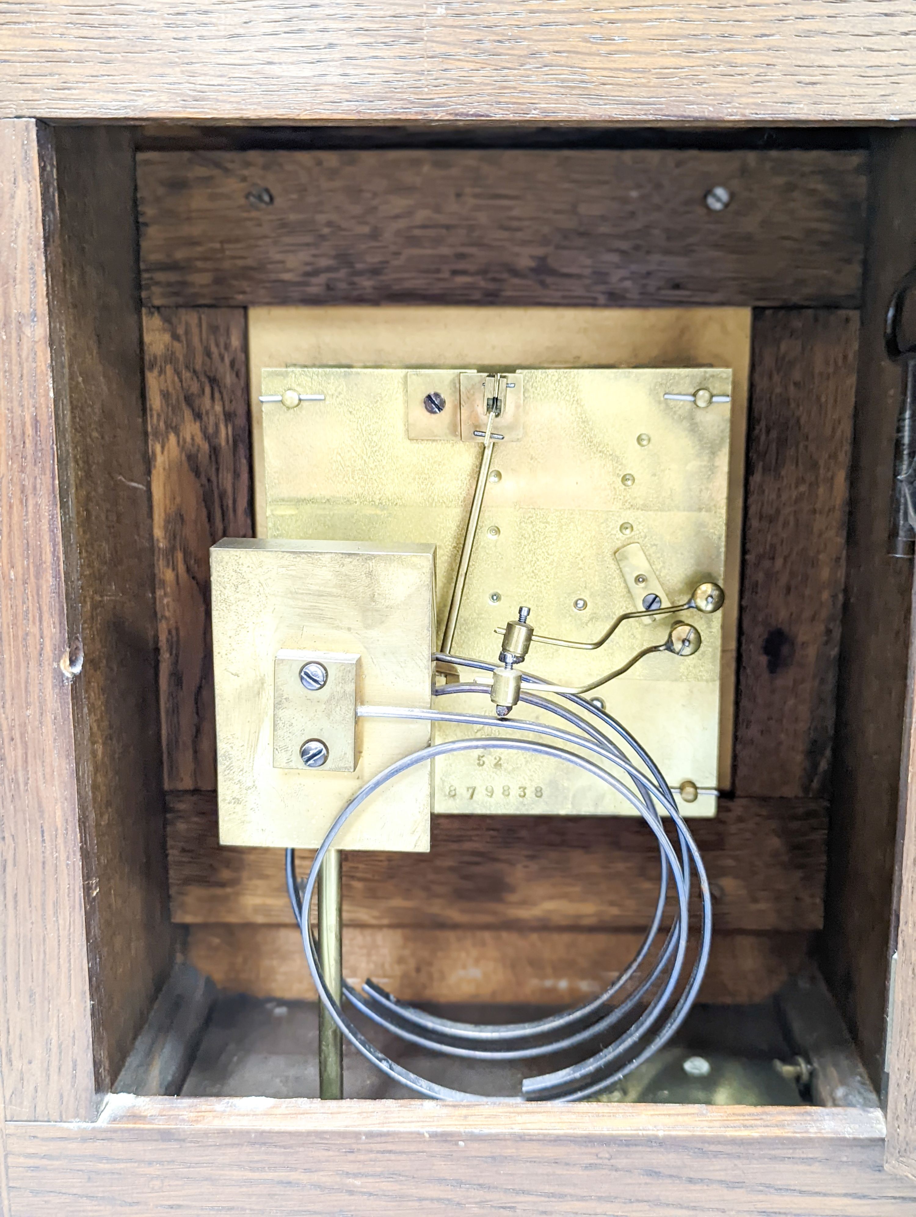 A late 19th century German oak cased eight day mantel clock